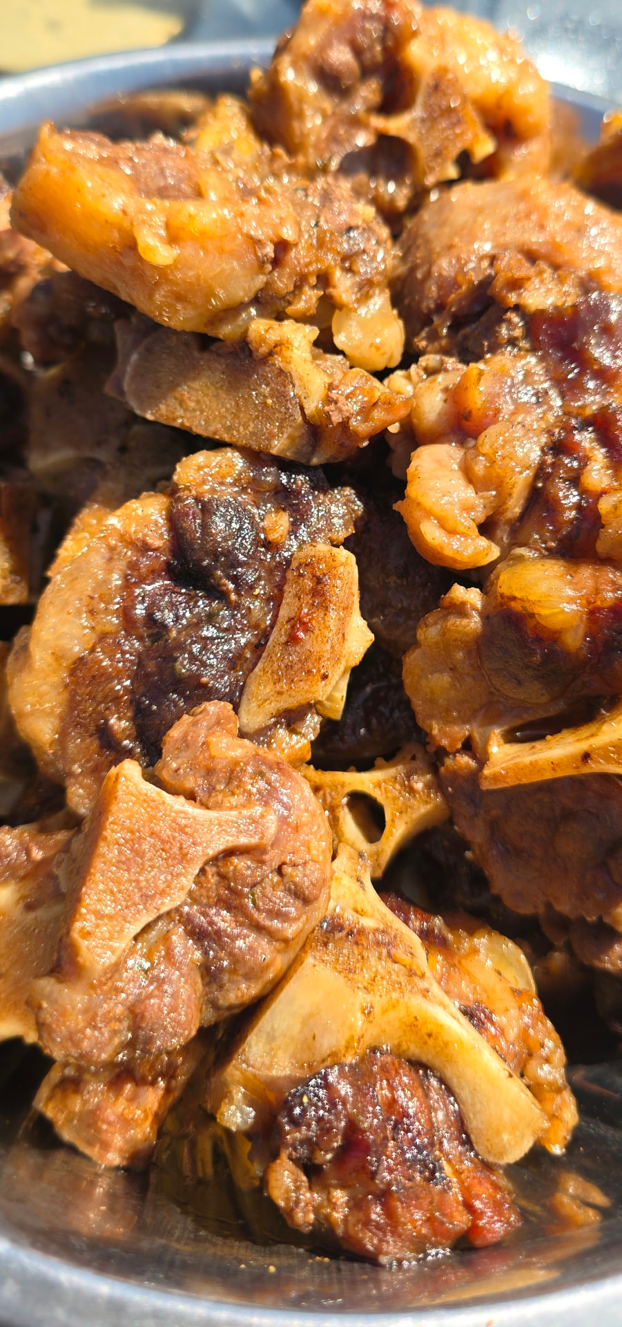 Braised oxtail glistening in a rich, spiced gravy